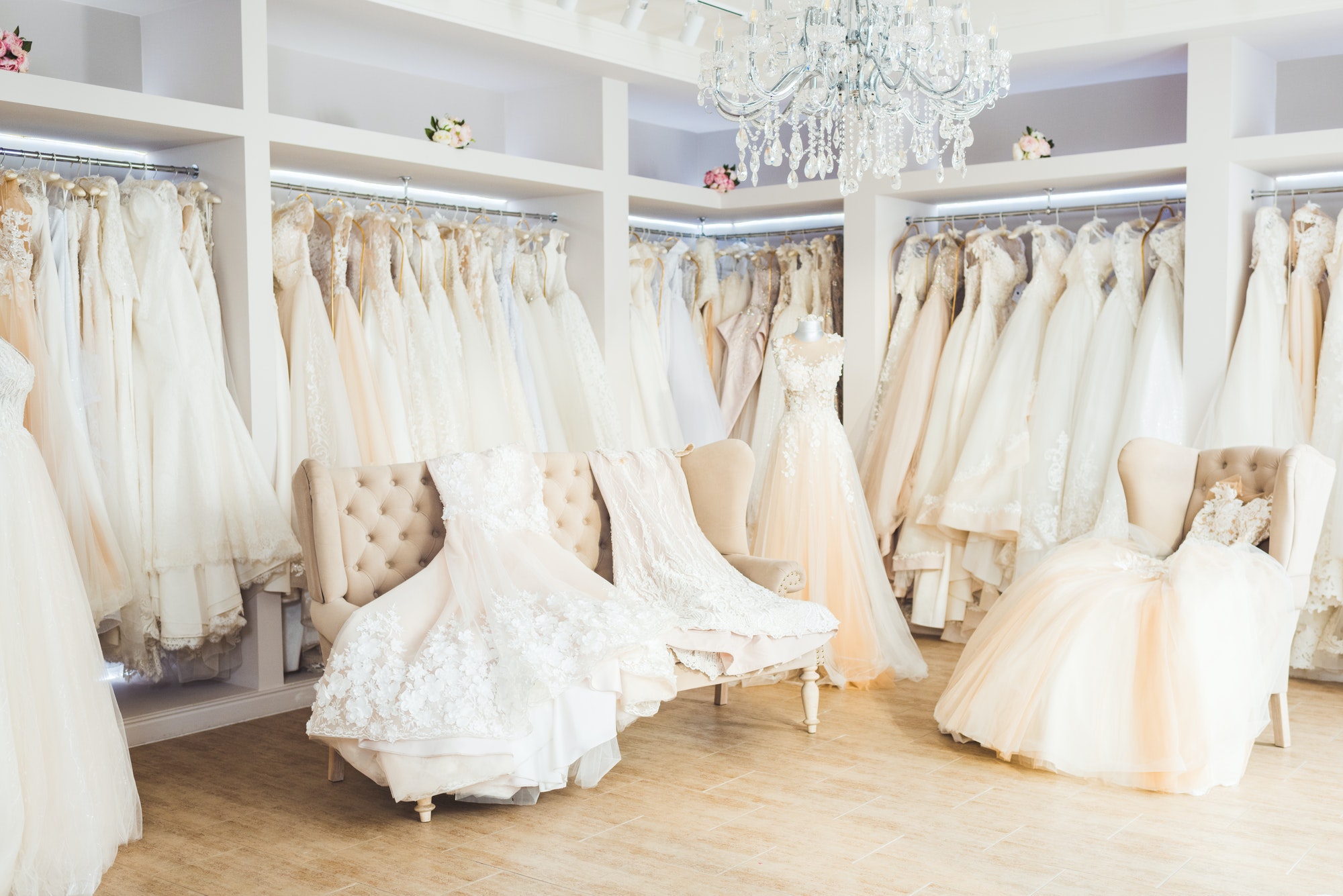 Beautiful wedding dresses on hangers in wedding atelier